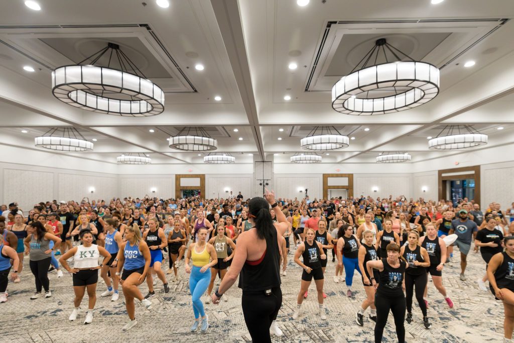 Hundreds of Burn Summit attendees exercise together during Friday morning Camp