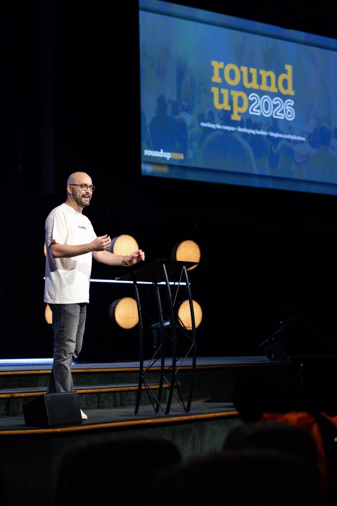 Drew Humphrey welcomes attendees from the stage at SBTC Collegiate Roundup 2026.