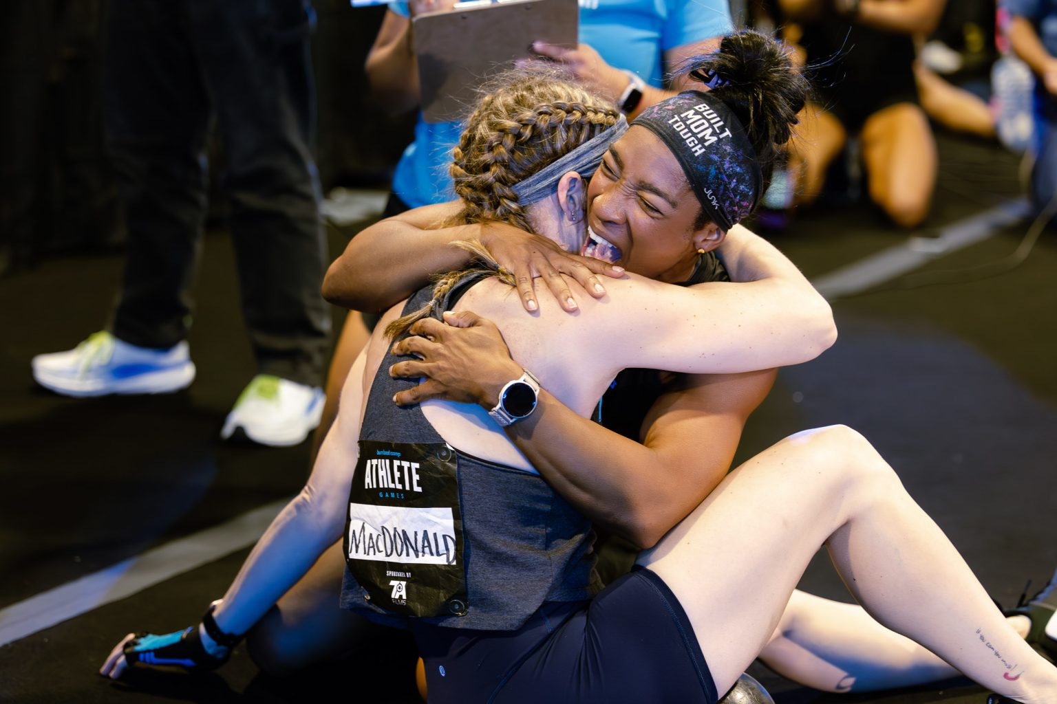 Two athletes embrace after finishing their heat, captured by our DFW event photography team